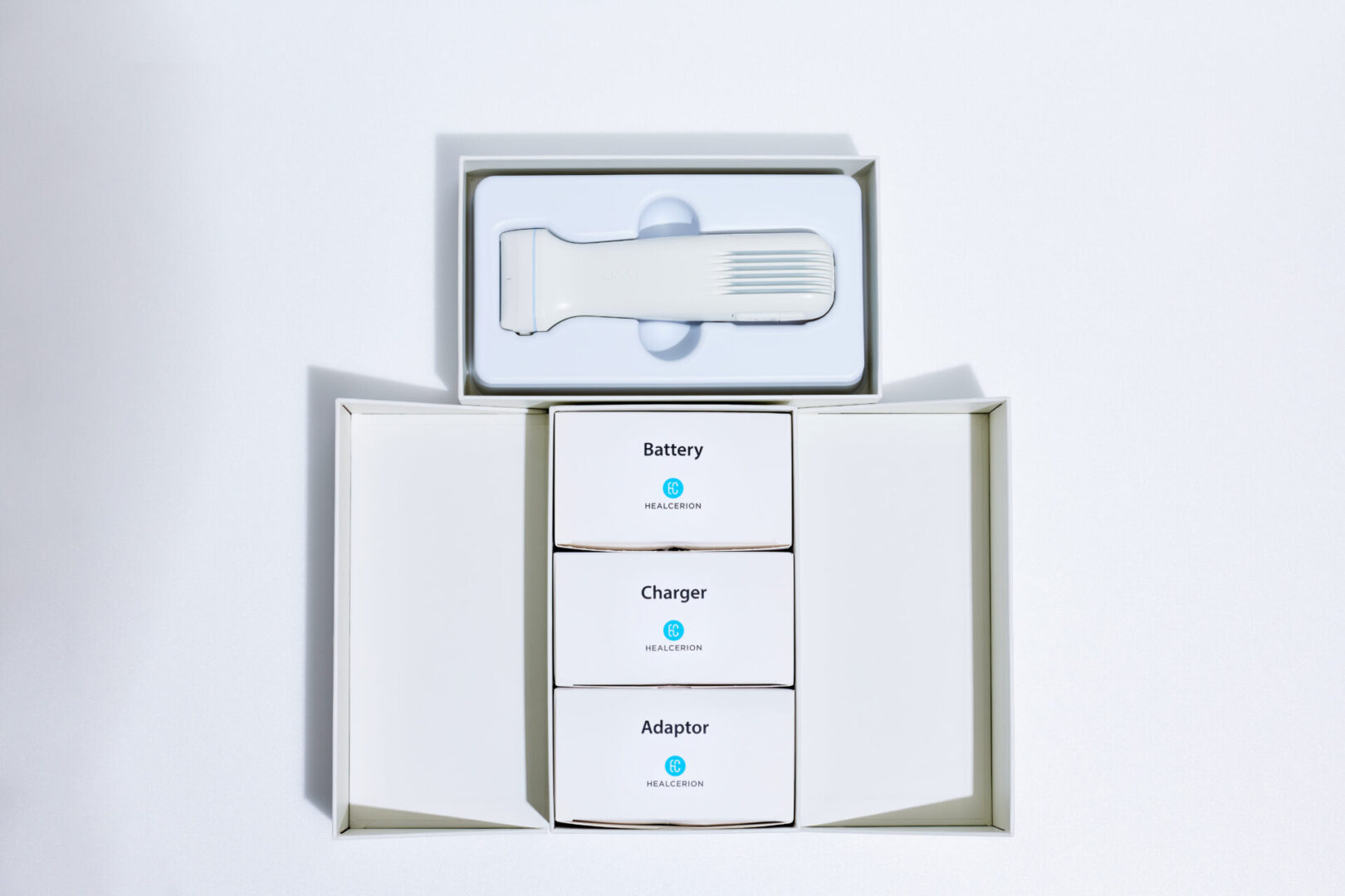 A white box with three batteries and an electric toothbrush.